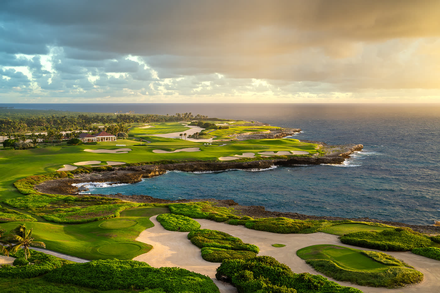 Oceanfront golf green with bunkers on a Punta Cana coastal course