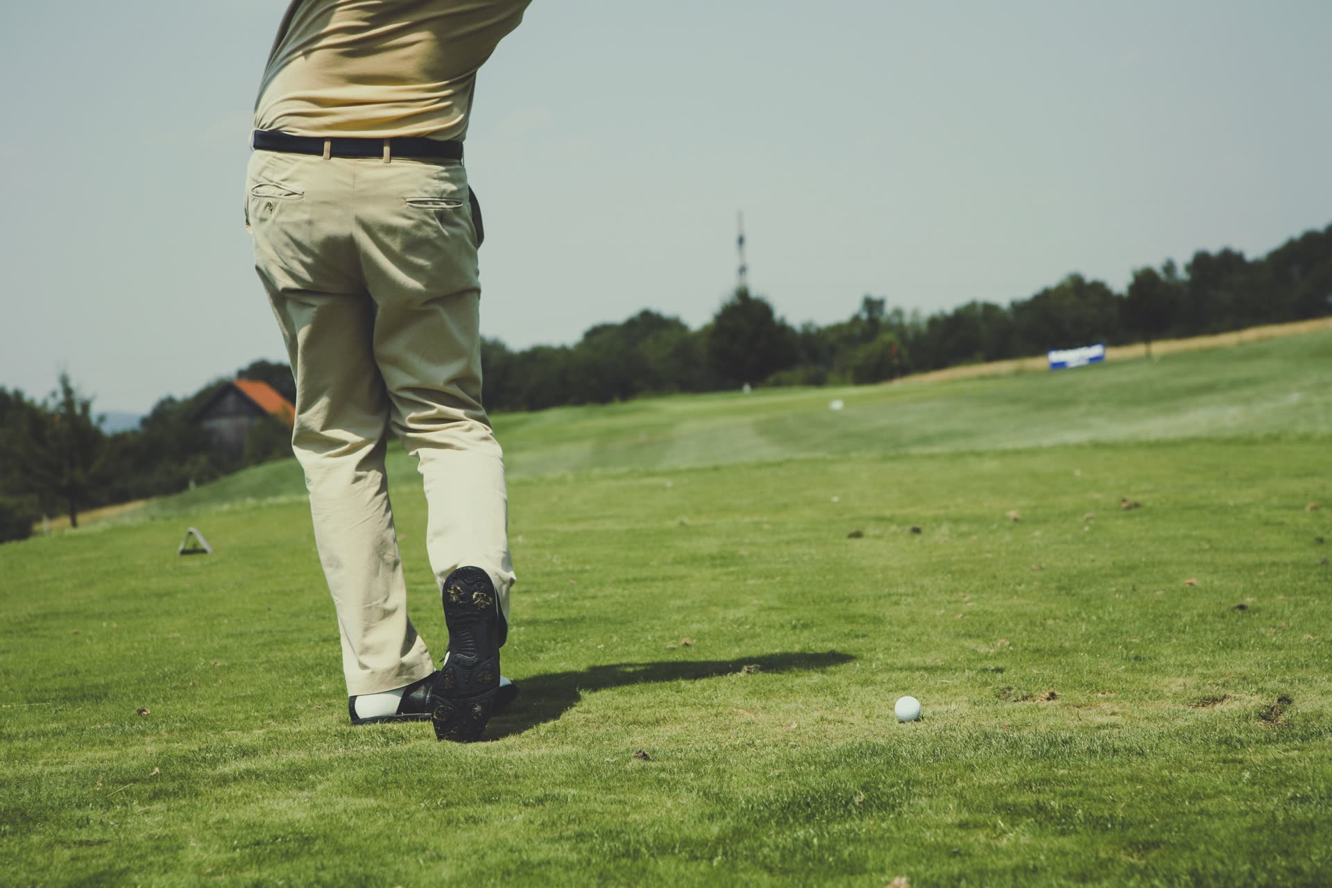 Golfer teeing off toward the fairway
